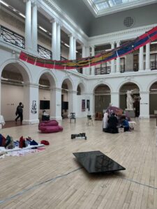Wide view of ECA Sculpture Court with contemporary art in a classical space. 