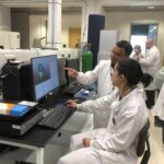 Two researchers in the Proteomics & Metabolomics facility looking an image on screen