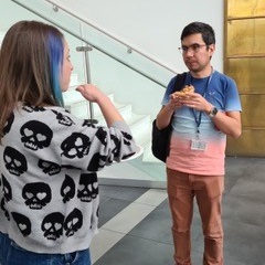 Two people eating pizza and chatting