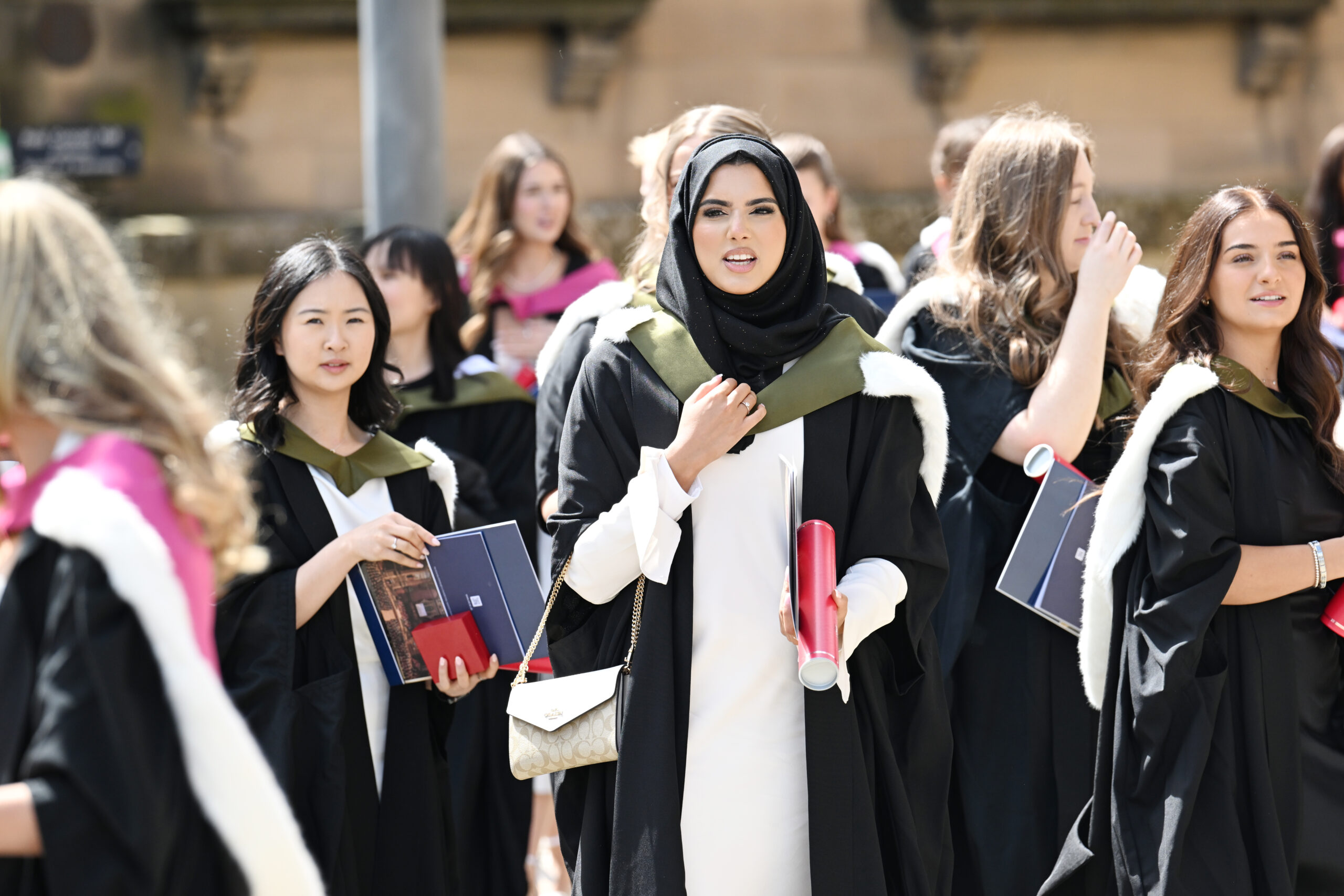 Graduates in gowns outside McEwan Hall.