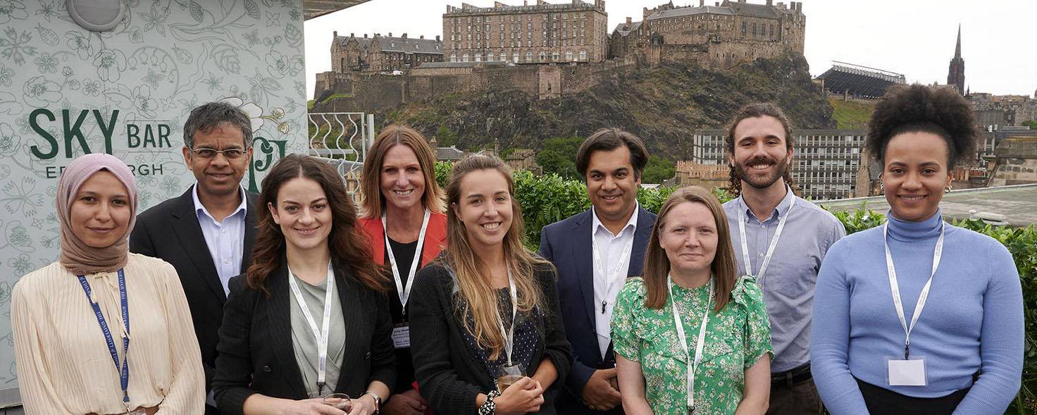 Group shot of team with Edinburgh Castle in background