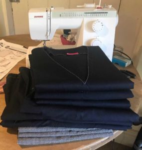 Newly sewn scrubs and a sewing machine