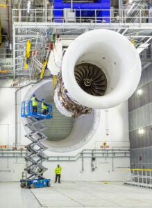 Jet engine Trent XWB and engineers in Derby Rolls-Royce testbed.