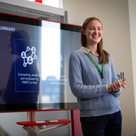 Veronika Pudilova giving a talk in front of a screen