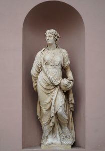 A classical statue stands in a niche
