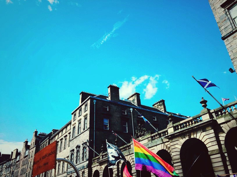 Blue skies over Edinburgh with Pride flags flying