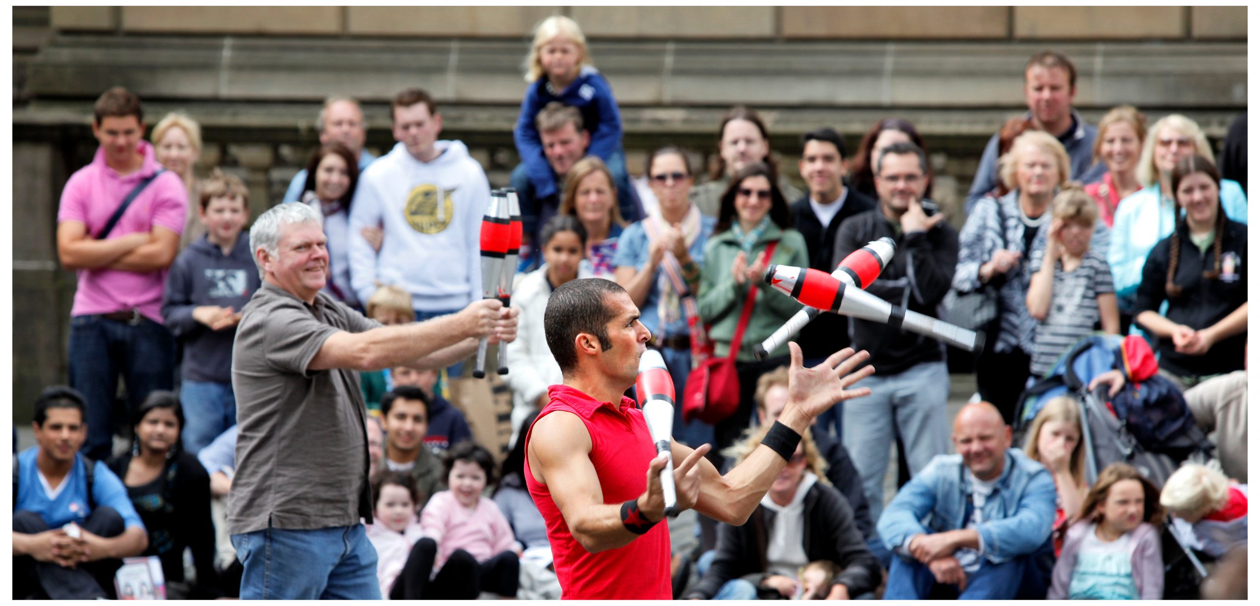 A juggler performs for a crowd during the Fringe festival in Edinburgh