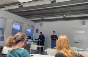 Rachel speaks in front of a group of people in a lecture room