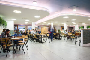 John McIntyre Conference Centre Restaurant interior with diners seated at tables, enjoying their meals and engaging in conversation.