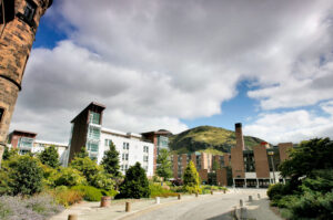 Pollock Halls - a variety of building styles with landscaped grounds, with Arthur's Seat - rising rising majestically in the background.
