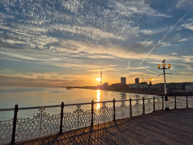A photo of a beautiful sunset reflecting off the water at Brighton pier.