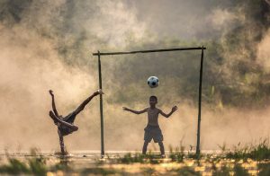Two boys playing football 