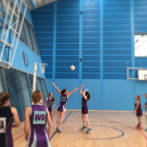 Netball player shooting for goal