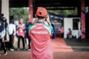 A person wearing a t-shirt reading volunteer