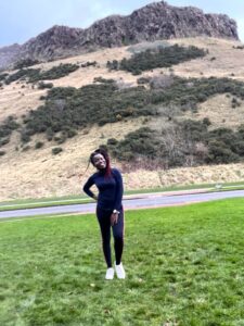 Photo of Adekiite in front of Arthur's Seat