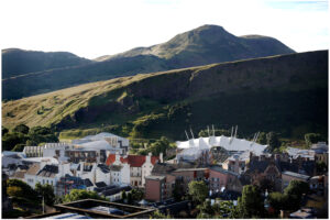Photograph depicts a view of Arthur's Seat, Edinburgh, in the sunshine.