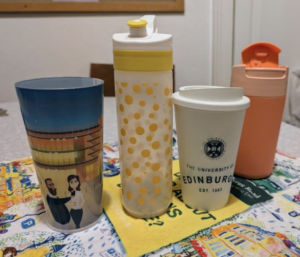 Image shows Michael's collection of reusable containers, including water bottles and a coffee cup.