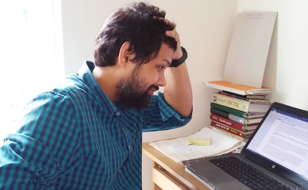 Image of Monjurul at his laptop