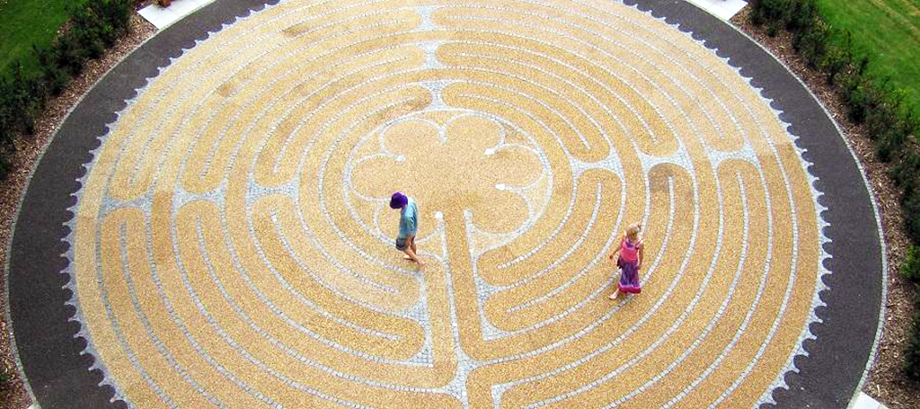 Two students seen from above walking around a labyrinth