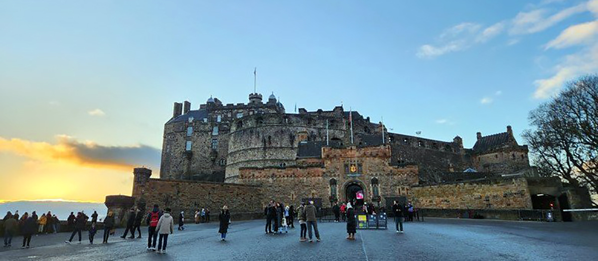 Edinburgh castle with a blue sky above it.