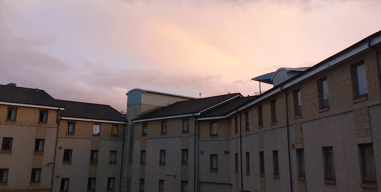 View of a colourful sky over Riego Halls of residence.