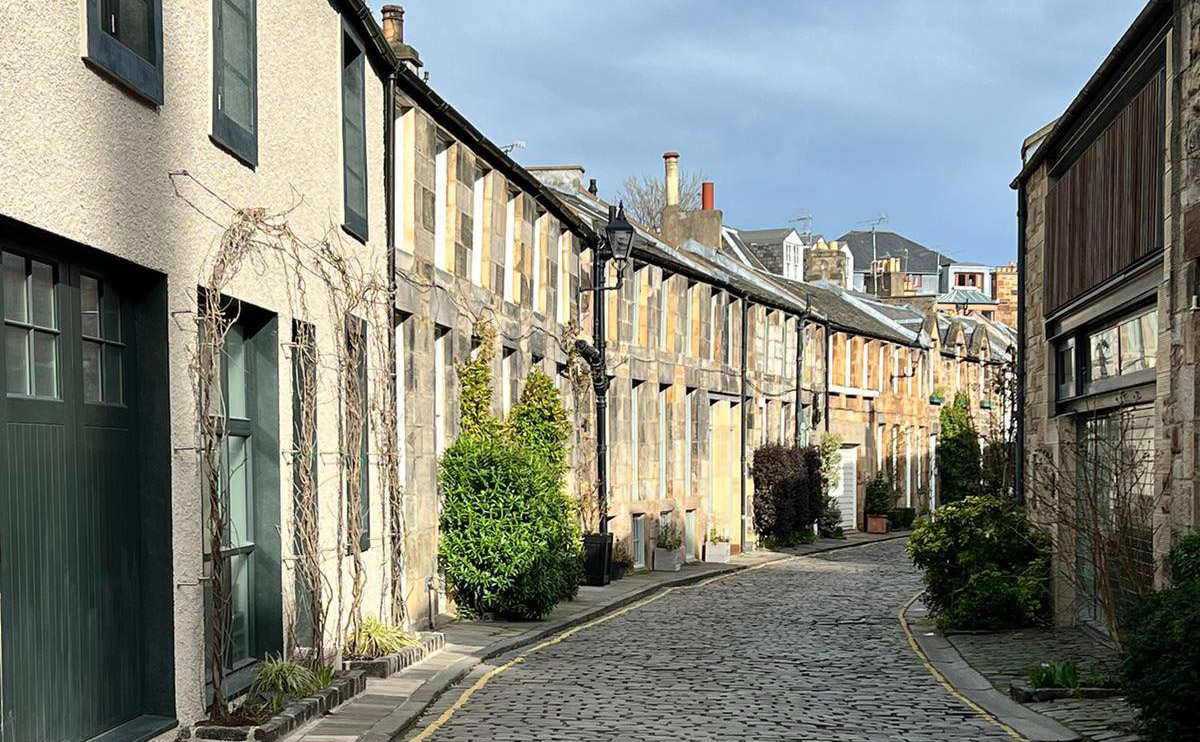 A quiet lane of houses in the sunshine.