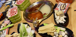 Food on a table with a hot pot