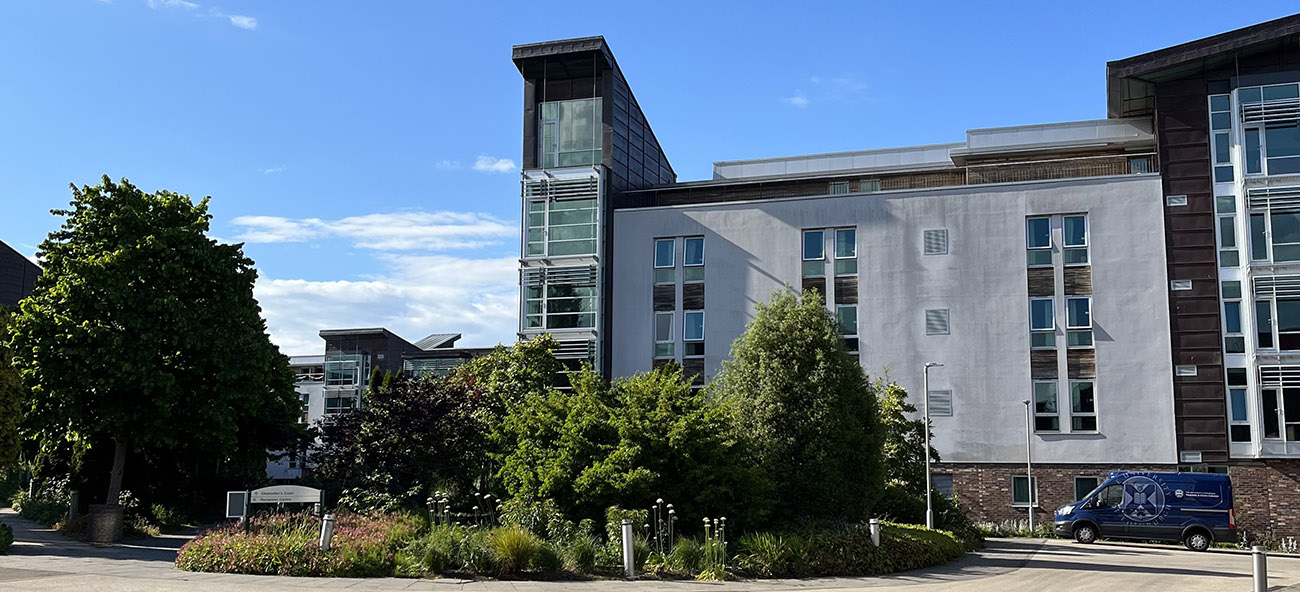 View of Pollock Halls against a blue sky.