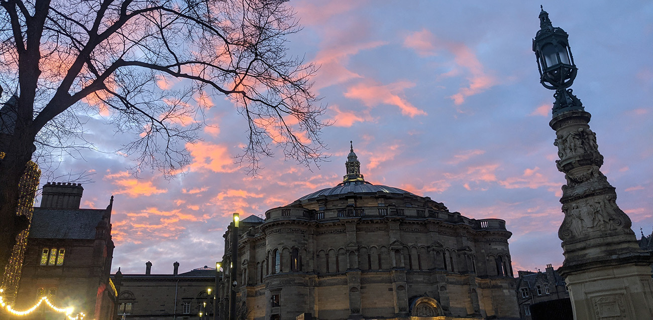 View of McEwan Hall at dusk with pink clouds in the sky.