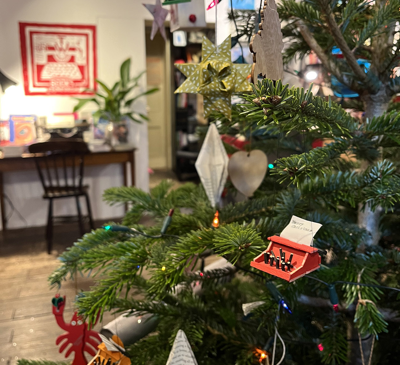 A Christmas tree with decorations inside a book shop.