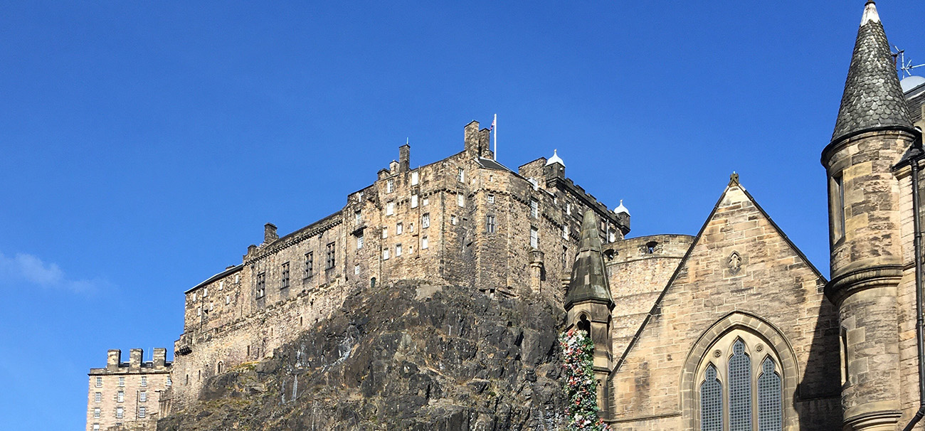 Edinburgh castle with blue clear skies above.