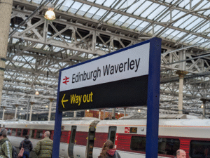 A sign in Edinburgh Waverley guiding people towards the "way out."