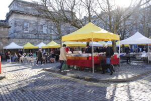 Yellow topped market stalls set up at the Leith Market, Edinburgh.