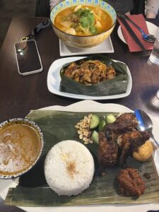 Several plates of Malaysian food.