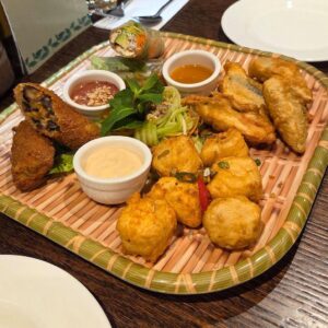 A sharing platter of food, including three small posts of sauce, at Non Viet, Edinburgh.