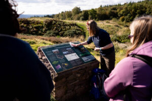 A person wipes a large sign clean.