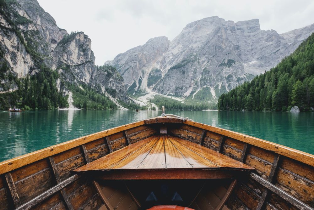 Close up of canoe in river surrounded by mountains