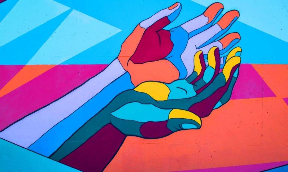 colourful illustration of one hand holding another hand.