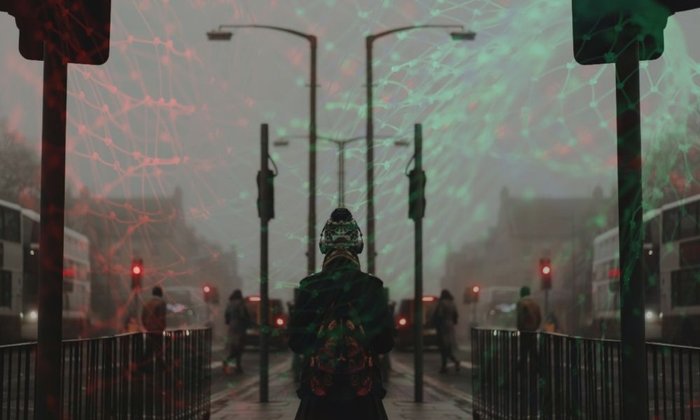 A photograph of a woman in a hat walking down the middle of a street with a networked grid in the sky