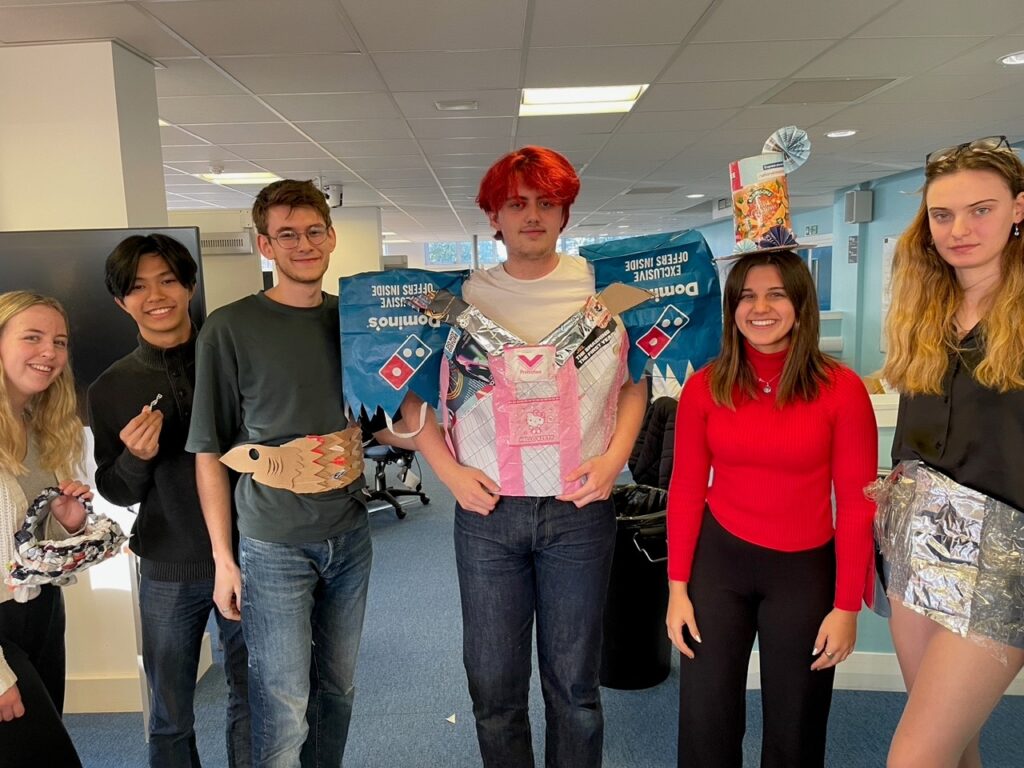 Students posing with their recycled fashion outfits