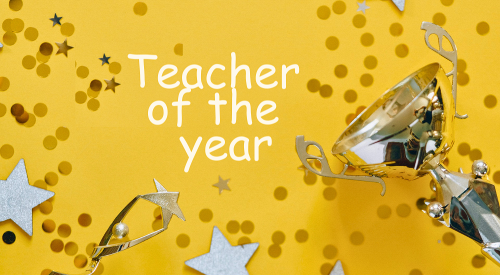 A photograph with a winning cup, decorative stars and glitters, with a text that reads Teacher of the year