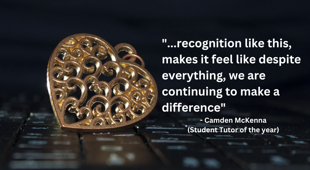 A bronze medallion on a key board, with text quoting Camden McKenna, Student Tutor of the year: 'recognition likes this, makes it feel like despite everything, we are continuing to make a difference'