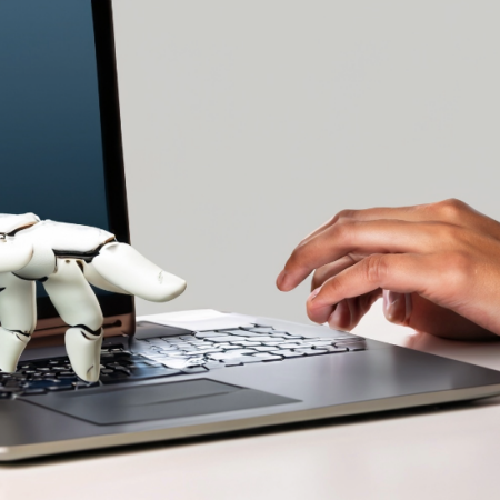 Laptop typing, one hand human and the other robot