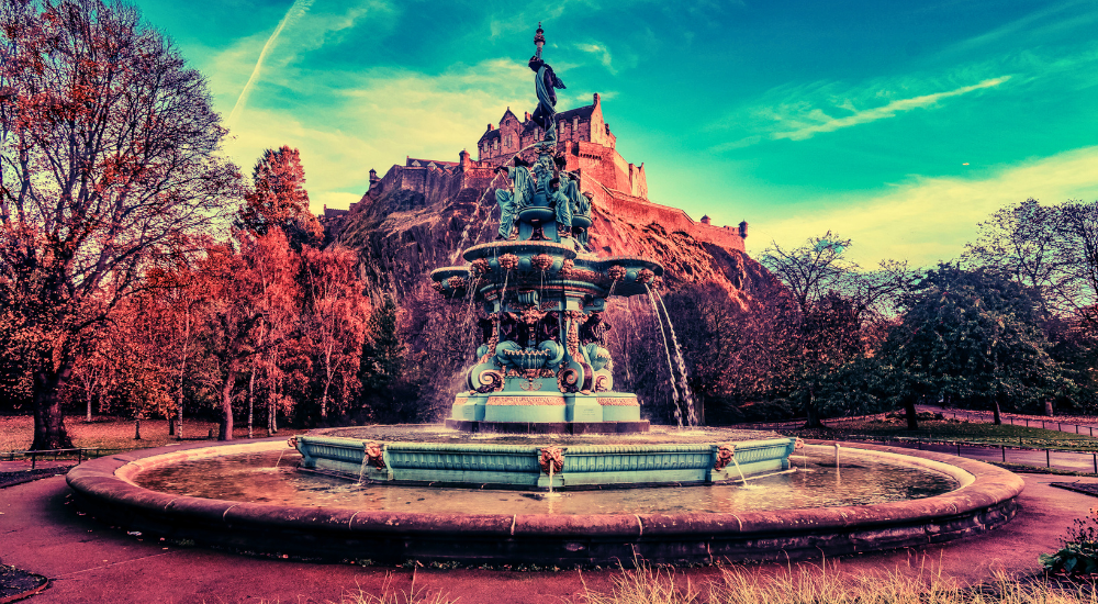 Photograph of the Princes street Gardens showing the fountain and Edinburgh castle