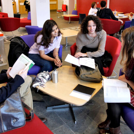 Group of students chatting around a table