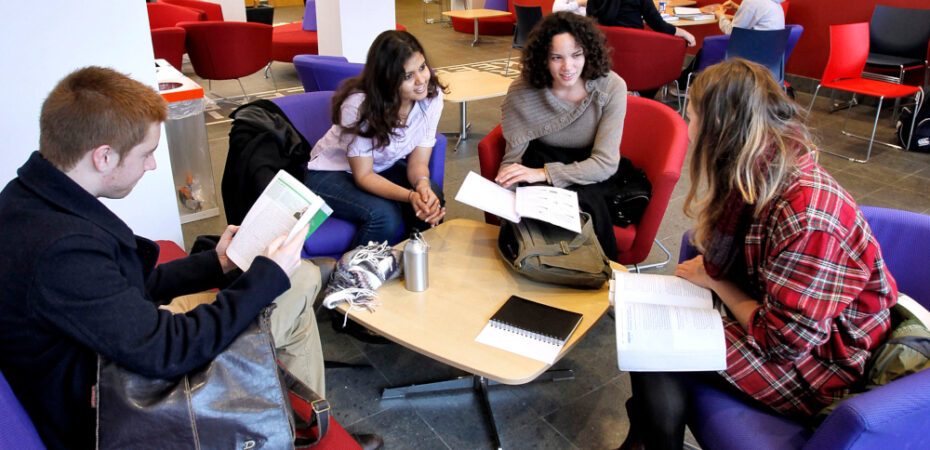 Group of students chatting around a table