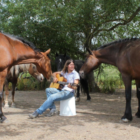 Please credit: Ellen Cochrane of Gaia Horsemanship.↗️ The image shows Glen's research collaborator Ellen Cochrane engaging in multi-species dialogue with a number of her equine friends. Ellen and Glen's work to explore the shift from the bit to the between, from domination to partnering, is grounded in principles of non-violent communication and are detailed in a recent paper in the Austral Journal of Veterinary Science (Cousquer, 2023)↗️.