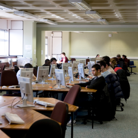 A photgraph showing a group of students working in the computer lab