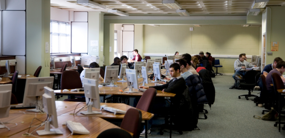 A photgraph showing a group of students working in the computer lab