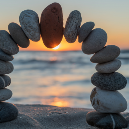 Stones in beach balanced to form an arc